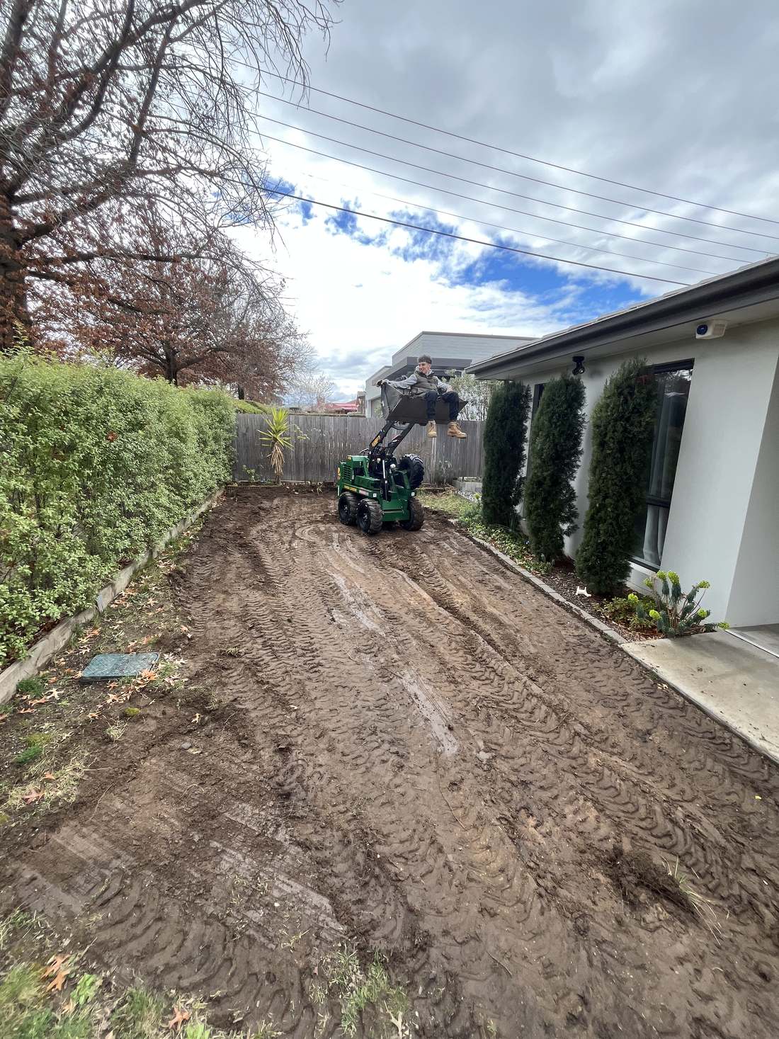 Before: back yard stripped to bare soil and rotary hoed ready for turf